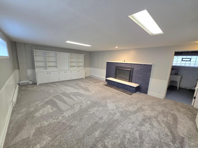 4643 N 108th St, Wauwatosa, WI 53225 - unfurnished living room with a fireplace, healthy amount of natural light, baseboard heating, carpet flooring, and wainscoting