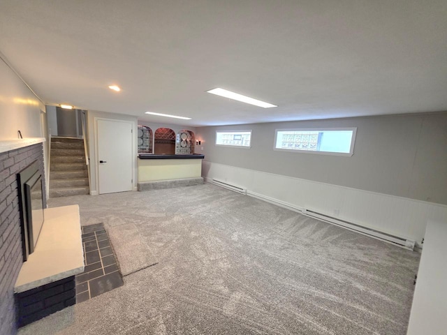4643 N 108th St, Wauwatosa, WI 53225 - below grade area with carpet, healthy amount of natural light, baseboard heating, and a fireplace