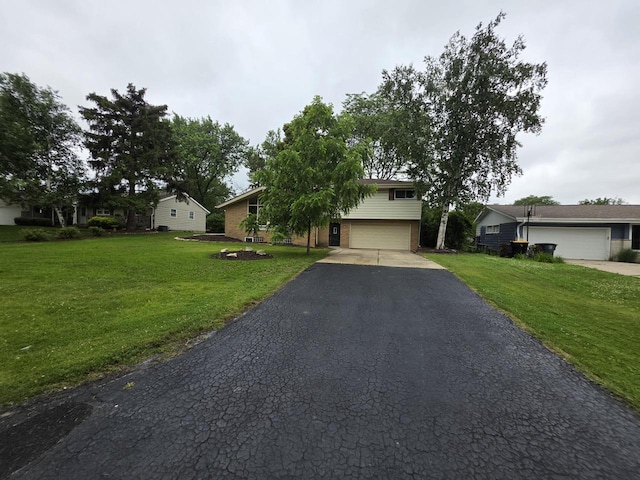 4643 N 108th St, Wauwatosa, WI 53225 - view of front of house with asphalt driveway, a garage, a front yard, and brick siding