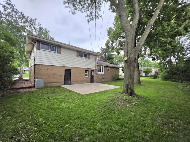 4643 N 108th St, Wauwatosa, WI 53225 - back of house featuring a patio area, brick siding, and a lawn