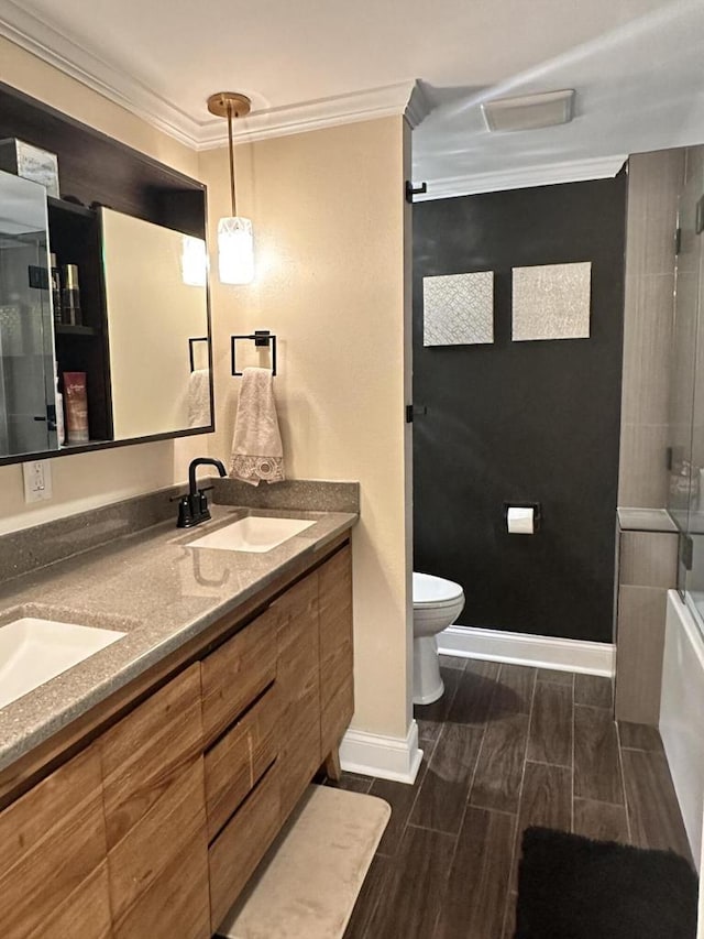 8221 Fairmont Ln, Greendale, WI 53129 - bathroom with crown molding, double vanity, wood tiled floors, and bath / shower combo with glass door