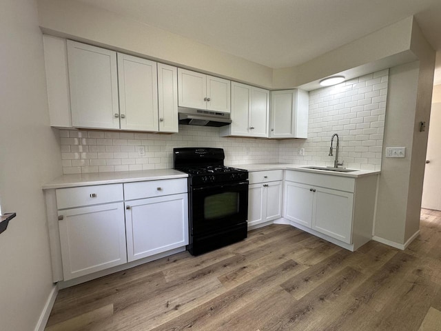 5145 Admiralty Ave Unit 5147, Racine, WI 53406 - kitchen with black gas range oven, under cabinet range hood, decorative backsplash, light countertops, and white cabinets