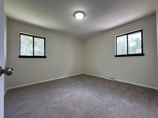 5145 Admiralty Ave Unit 5147, Racine, WI 53406 - unfurnished room featuring plenty of natural light and dark carpet