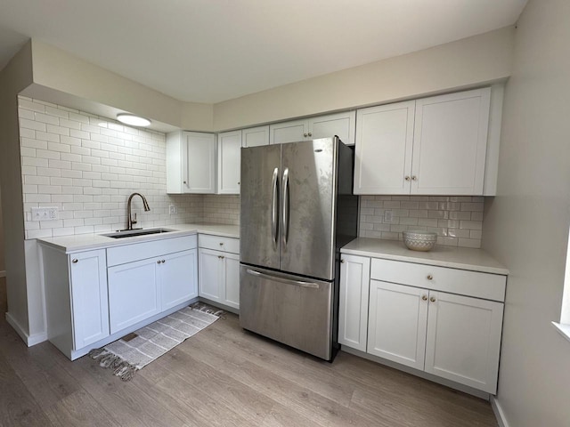 5145 Admiralty Ave Unit 5147, Racine, WI 53406 - kitchen with freestanding refrigerator, light wood-style flooring, and backsplash