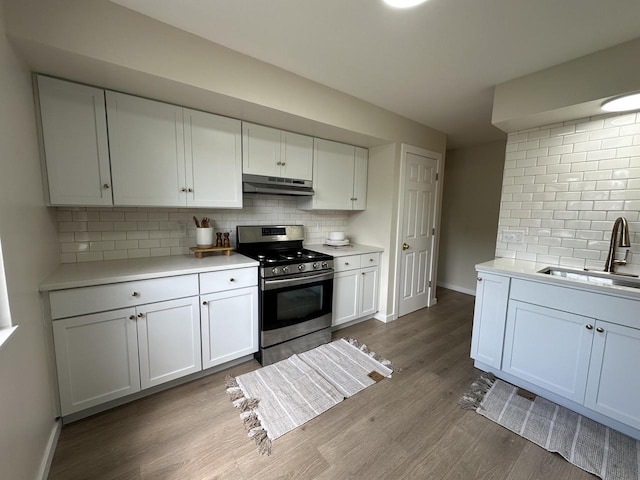 5145 Admiralty Ave Unit 5147, Racine, WI 53406 - kitchen with gas range, under cabinet range hood, backsplash, and dark wood-type flooring