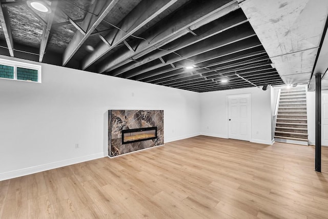 7314 25th Ave, Kenosha, WI 53143 - finished basement with stairway, a fireplace, and wood finished floors