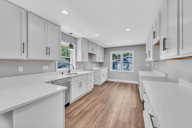 7314 25th Ave, Kenosha, WI 53143 - kitchen featuring stainless steel dishwasher, light stone counters, light wood-style floors, recessed lighting, and decorative light fixtures