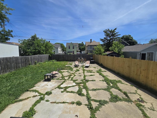 1635 Grand Ave, Racine, WI 53403 - fenced backyard featuring a patio area and a residential view