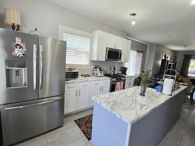 1635 Grand Ave, Racine, WI 53403 - kitchen featuring stainless steel appliances, light wood-style floors, and white cabinetry