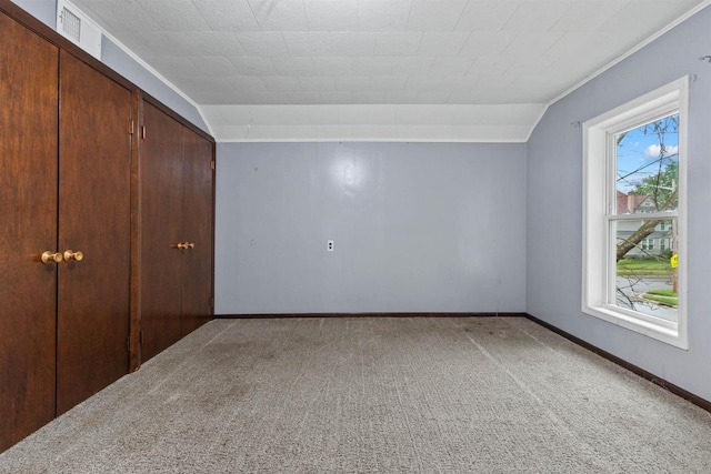 951 Oak St, Wisconsin Rapids, WI 54494 - unfurnished bedroom featuring carpet flooring, lofted ceiling, and a closet