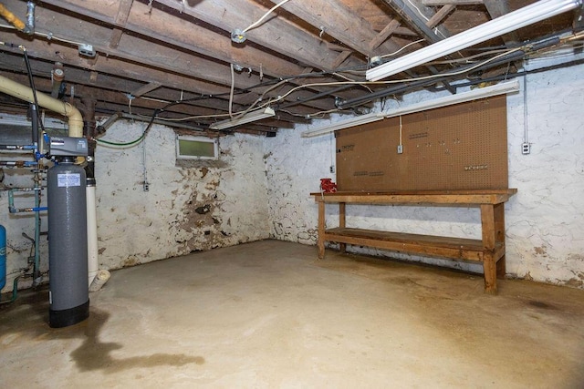5046 State Highway 33, West Bend, WI 53095 - unfinished basement featuring a workshop area, a water softener system, and a water pressure tank