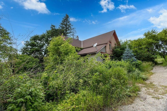5046 State Highway 33, West Bend, WI 53095 - view of home's exterior with a chimney and roof with shingles