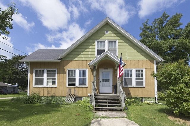 134 N Watertown St, Waupun, WI 53963 - bungalow featuring a front lawn and board and batten siding