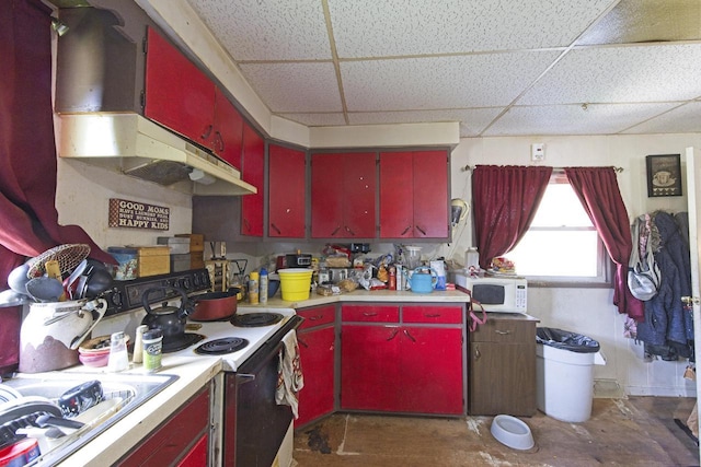 134 N Watertown St, Waupun, WI 53963 - kitchen featuring red cabinetry, a paneled ceiling, white appliances, light countertops, and concrete flooring