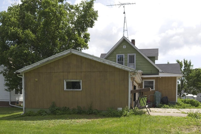 134 N Watertown St, Waupun, WI 53963 - back of property with a lawn and a chimney