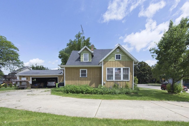 134 N Watertown St, Waupun, WI 53963 - view of front of home featuring concrete driveway, an attached garage, and a front yard