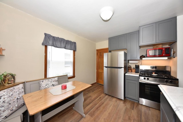 2044 S 96th St, West Allis, WI 53227 - kitchen with appliances with stainless steel finishes, gray cabinets, light countertops, and light wood-type flooring