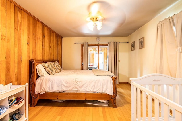 E2880 Witcraft Ridge Rd, Genoa, WI 54632 - bedroom featuring light wood finished floors, wood walls, and a ceiling fan