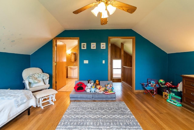 E2880 Witcraft Ridge Rd, Genoa, WI 54632 - bedroom featuring wood finished floors, vaulted ceiling, ensuite bathroom, and ceiling fan