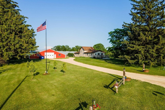 E2880 Witcraft Ridge Rd, Genoa, WI 54632 - view of front of house with driveway, a front yard, a detached garage, and an outdoor structure