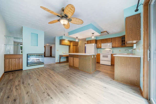 2232 N Cloudview Dr, Appleton, WI 54914 - kitchen with white appliances, light wood finished floors, brown cabinets, light countertops, and a center island