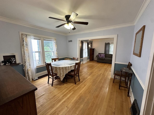 110 Bowen St, Oshkosh, WI 54901 - dining space featuring a ceiling fan, light wood-style floors, and crown molding