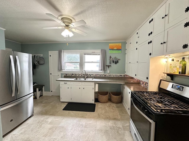110 Bowen St, Oshkosh, WI 54901 - kitchen with stainless steel appliances, a ceiling fan, white cabinetry, and a textured ceiling