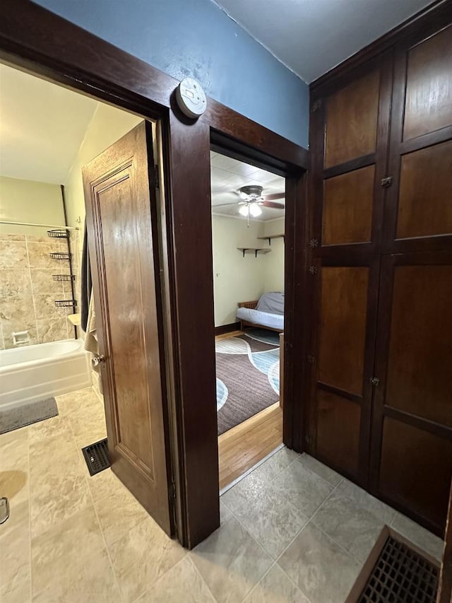 110 Bowen St, Oshkosh, WI 54901 - full bath featuring a ceiling fan, tub / shower combination, and tile patterned flooring