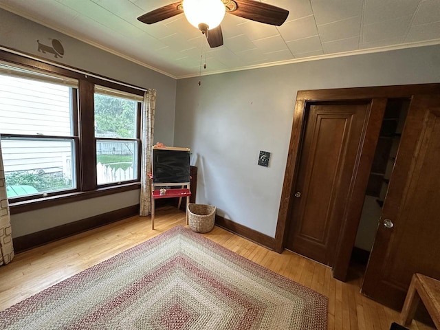 110 Bowen St, Oshkosh, WI 54901 - unfurnished bedroom with ornamental molding, light wood-style flooring, and a ceiling fan