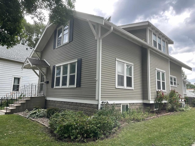 110 Bowen St, Oshkosh, WI 54901 - view of side of home featuring a lawn