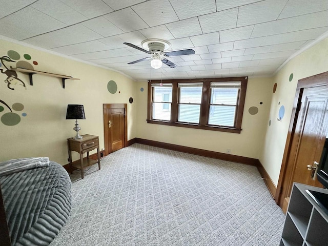 110 Bowen St, Oshkosh, WI 54901 - living area featuring crown molding, a ceiling fan, and light colored carpet