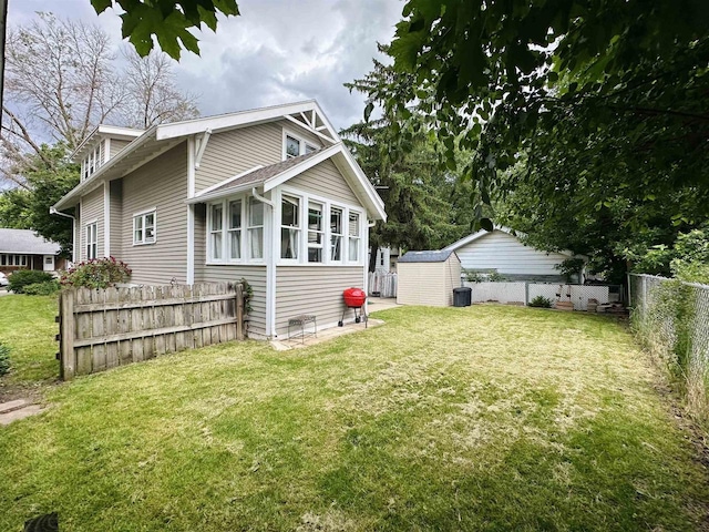 110 Bowen St, Oshkosh, WI 54901 - rear view of house featuring a shed and a fenced backyard