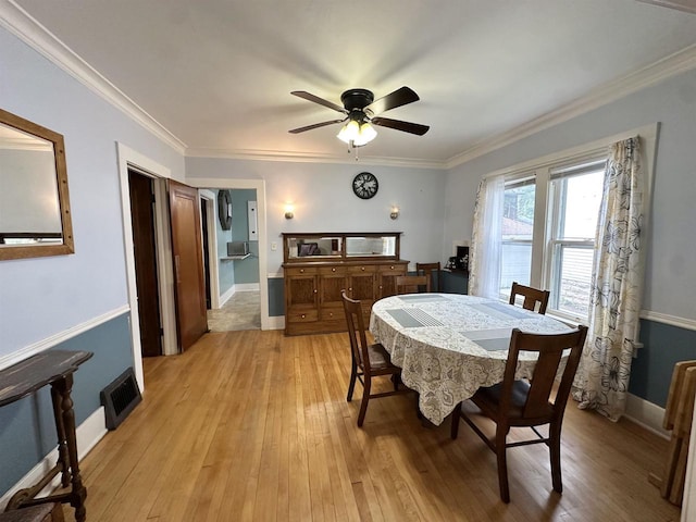 110 Bowen St, Oshkosh, WI 54901 - dining room with light wood-style floors, a ceiling fan, and ornamental molding