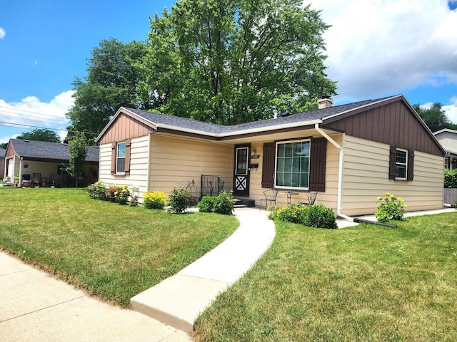 5100 16th St, Racine, WI 53406 - single story home featuring board and batten siding, a front yard, and a chimney