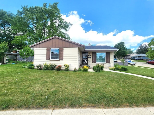 5100 16th St, Racine, WI 53406 - view of front facade featuring a front lawn and a chimney