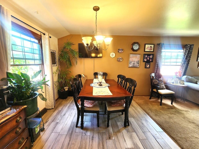 5100 16th St, Racine, WI 53406 - dining space featuring a chandelier, light wood-style flooring, and vaulted ceiling