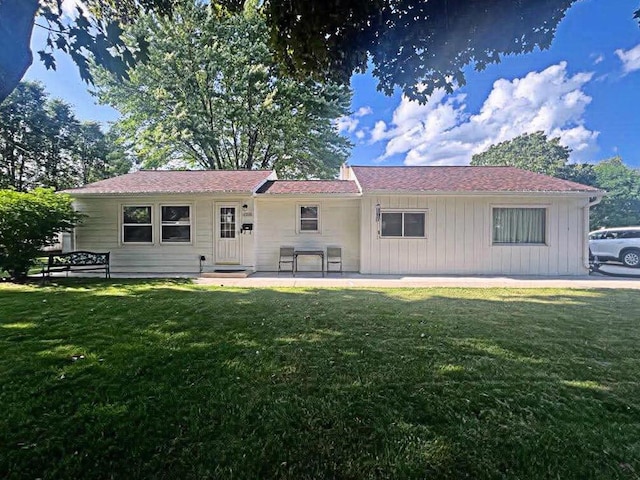 12308 W Walker St, West Allis, WI 53214 - rear view of house with a lawn and board and batten siding