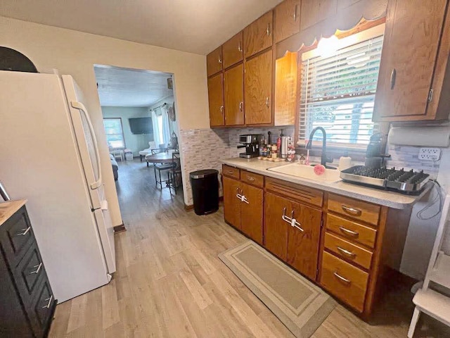 12308 W Walker St, West Allis, WI 53214 - kitchen featuring freestanding refrigerator, light wood-style flooring, brown cabinets, and light countertops