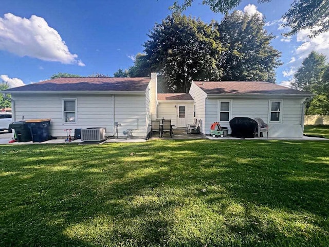 12308 W Walker St, West Allis, WI 53214 - rear view of house with a yard, a patio area, and a chimney