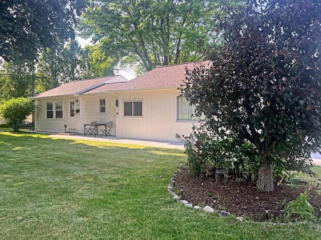 12308 W Walker St, West Allis, WI 53214 - rear view of house featuring a lawn and a patio