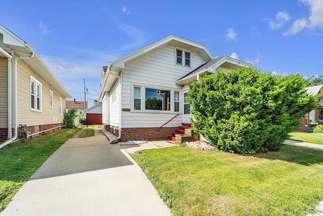 2813 21st St, Racine, WI 53403 - view of front facade featuring a front lawn, entry steps, and concrete driveway