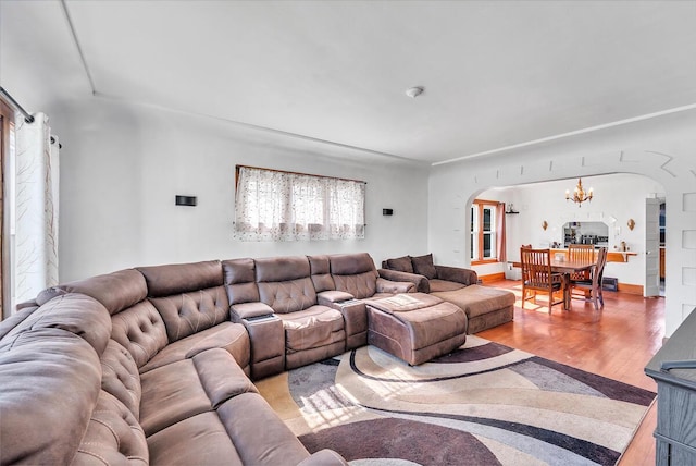 2813 21st St, Racine, WI 53403 - living area featuring arched walkways, light wood-style flooring, and a chandelier