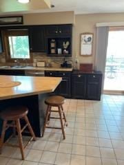 2309 E Pine Tree Ct, Milton, WI 53563 - kitchen with a kitchen bar, oven, and dark cabinets