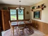 2309 E Pine Tree Ct, Milton, WI 53563 - dining space featuring a chandelier, wainscoting, and wood walls
