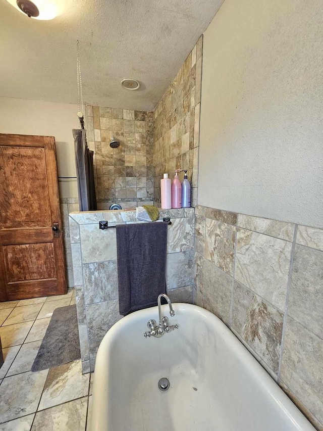 556 E Jefferson St, Waupun, WI 53963 - full bathroom with a freestanding tub, tiled shower, and a textured ceiling