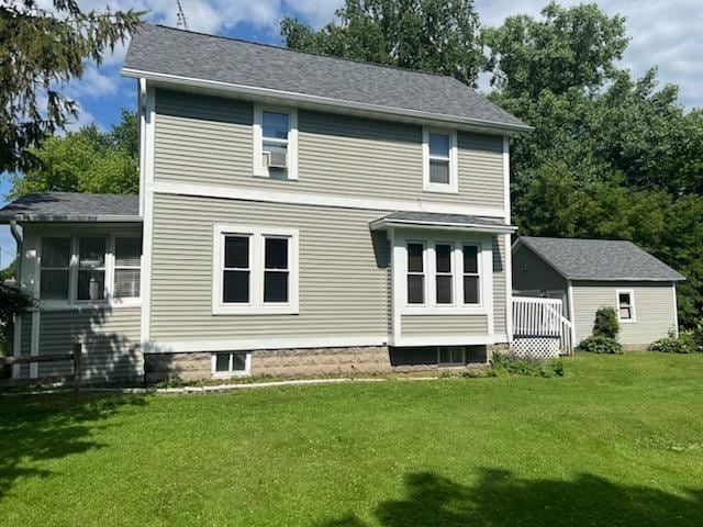 556 E Jefferson St, Waupun, WI 53963 - rear view of house featuring a yard