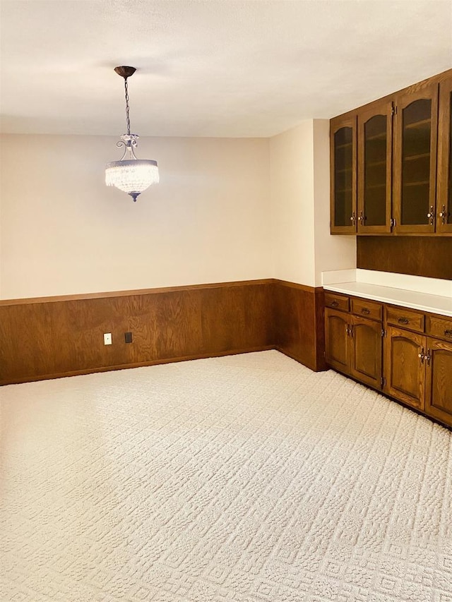 5572 Stable View Ln, Fitchburg, WI 53575 - bar featuring a wainscoted wall, light carpet, pendant lighting, and wood walls