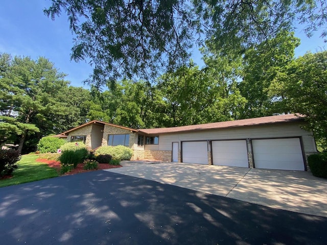 5572 Stable View Ln, Fitchburg, WI 53575 - view of front facade with concrete driveway, stone siding, and a garage