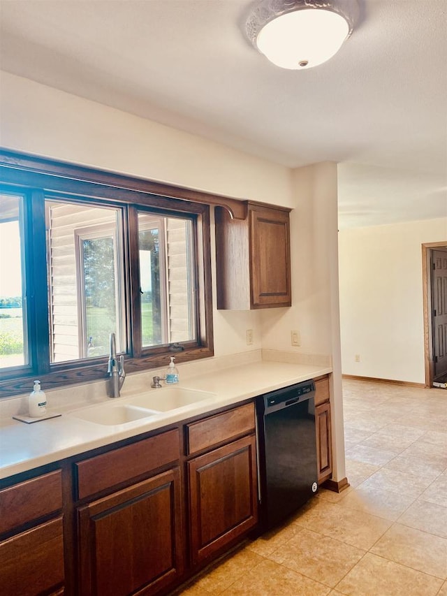 5572 Stable View Ln, Fitchburg, WI 53575 - kitchen with black dishwasher, light countertops, and light tile patterned floors