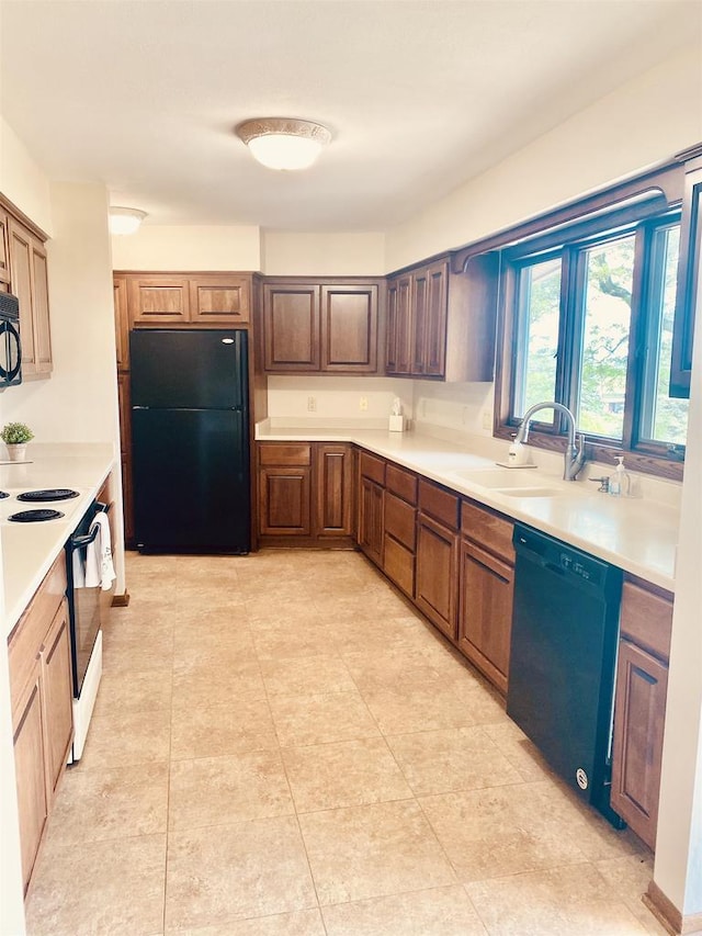 5572 Stable View Ln, Fitchburg, WI 53575 - kitchen featuring black appliances, light countertops, and light tile patterned floors